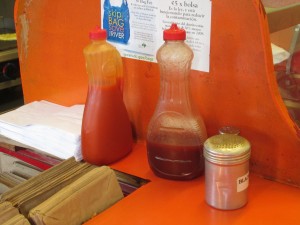 the mumbo sauce (middle) kept in repurposed syrup bottles at Smokey's
