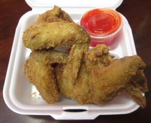 the fried chicken wings (with neon-colored mumbo sauce on the side) at Panda Café