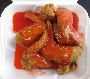 fried chicken wings slathered with a neon mumbo sauce at Wing Wah