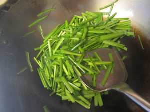 stir-frying Chinese chives during the last step