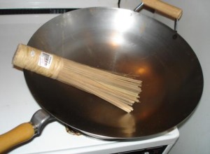 a wok with traditional scrub brush with bamboo bristles (photo courtesy of W.K. Leung) 